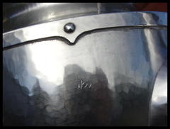 Close-up of scratches on side of teapot.